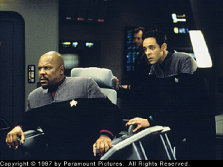 Sisko and Bashir hold on while under attack